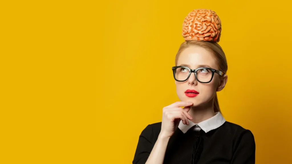 Girl holding artificial human brain on his head